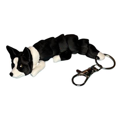 Black and white Cardigan Corgie keychain designed kekreations and 3D printed by 3D marvels in Ireland. It doubles as a fidget toy with its articulated design which was printed as one piece.