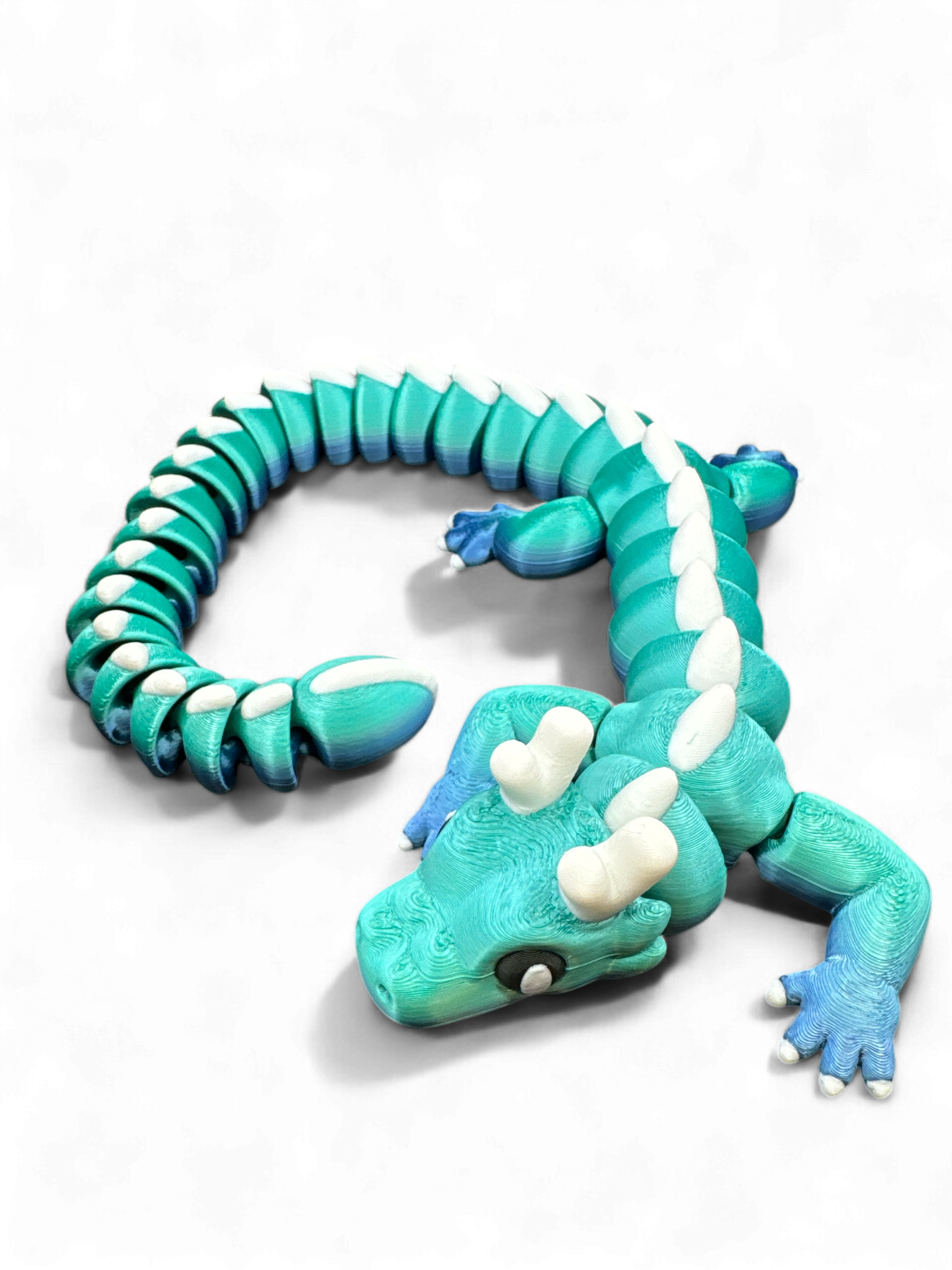 blue green cute dragon as 3d-printed collectible fidget toy by Zou3D and 3D Marvels