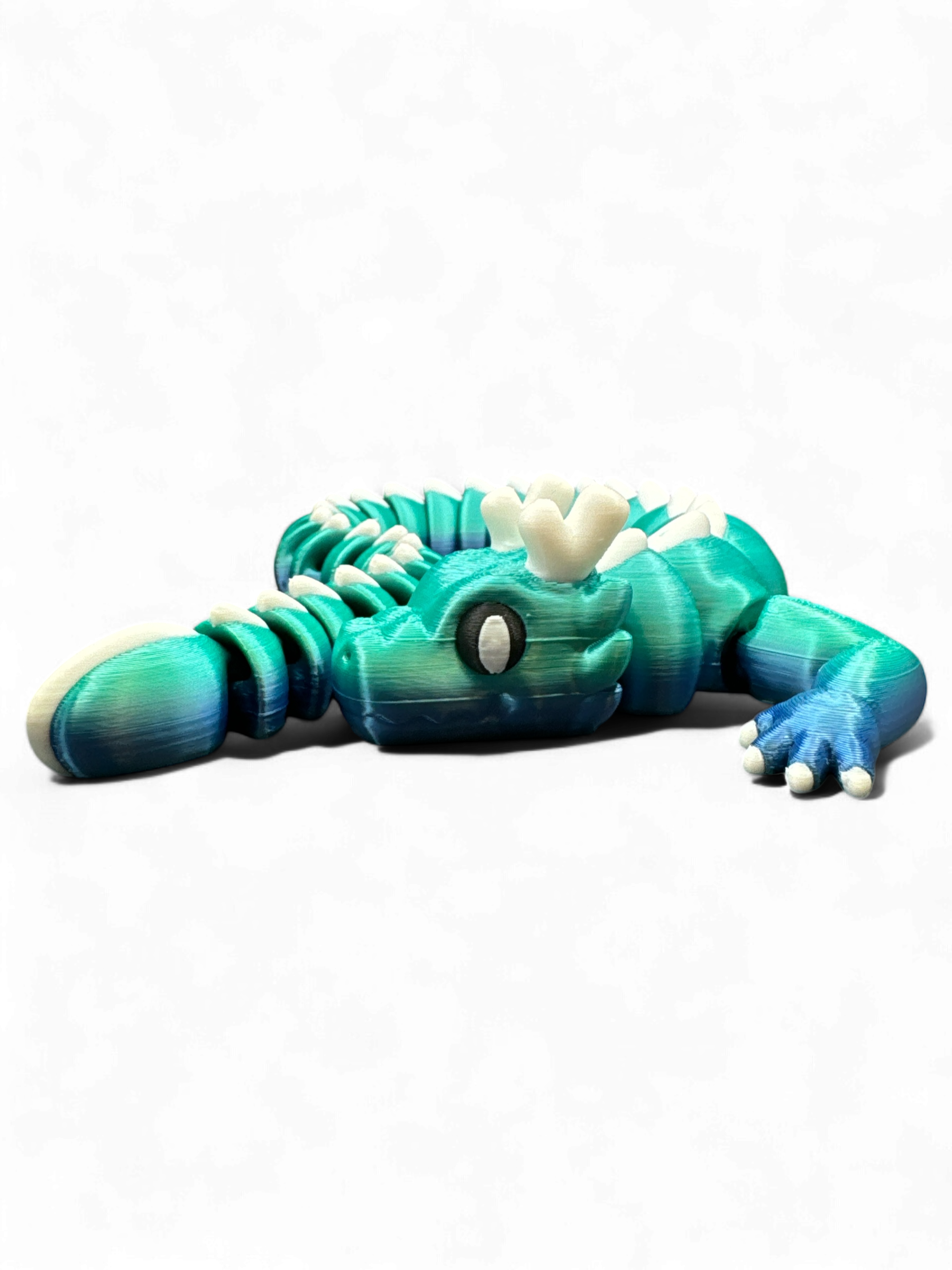 blue green cute dragon as 3d-printed collectible fidget toy by Zou3D and 3D Marvels