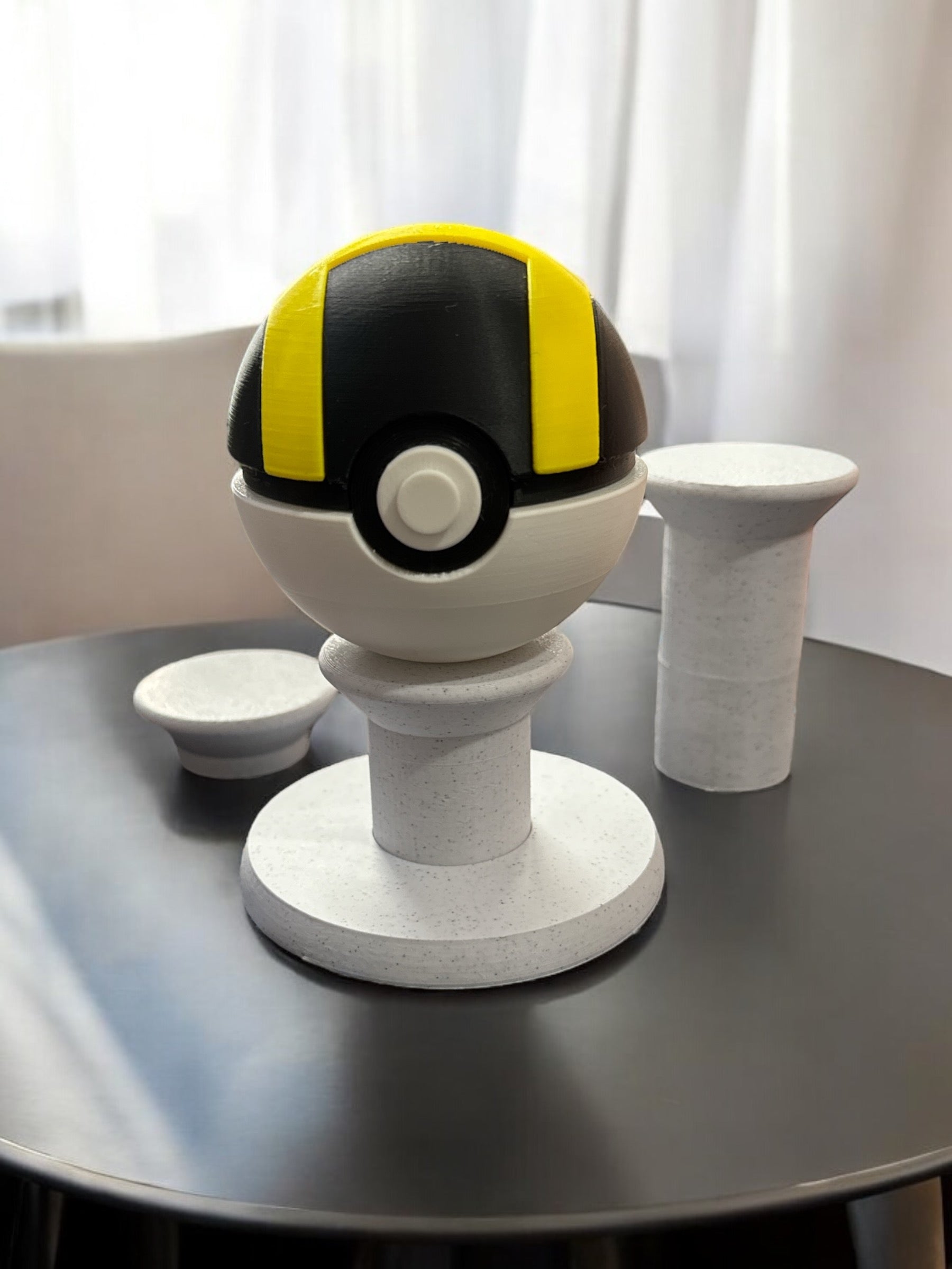 3D printed pedestal with an Ultra Pokemon ball. The pedestal is displayed in white stone PLA